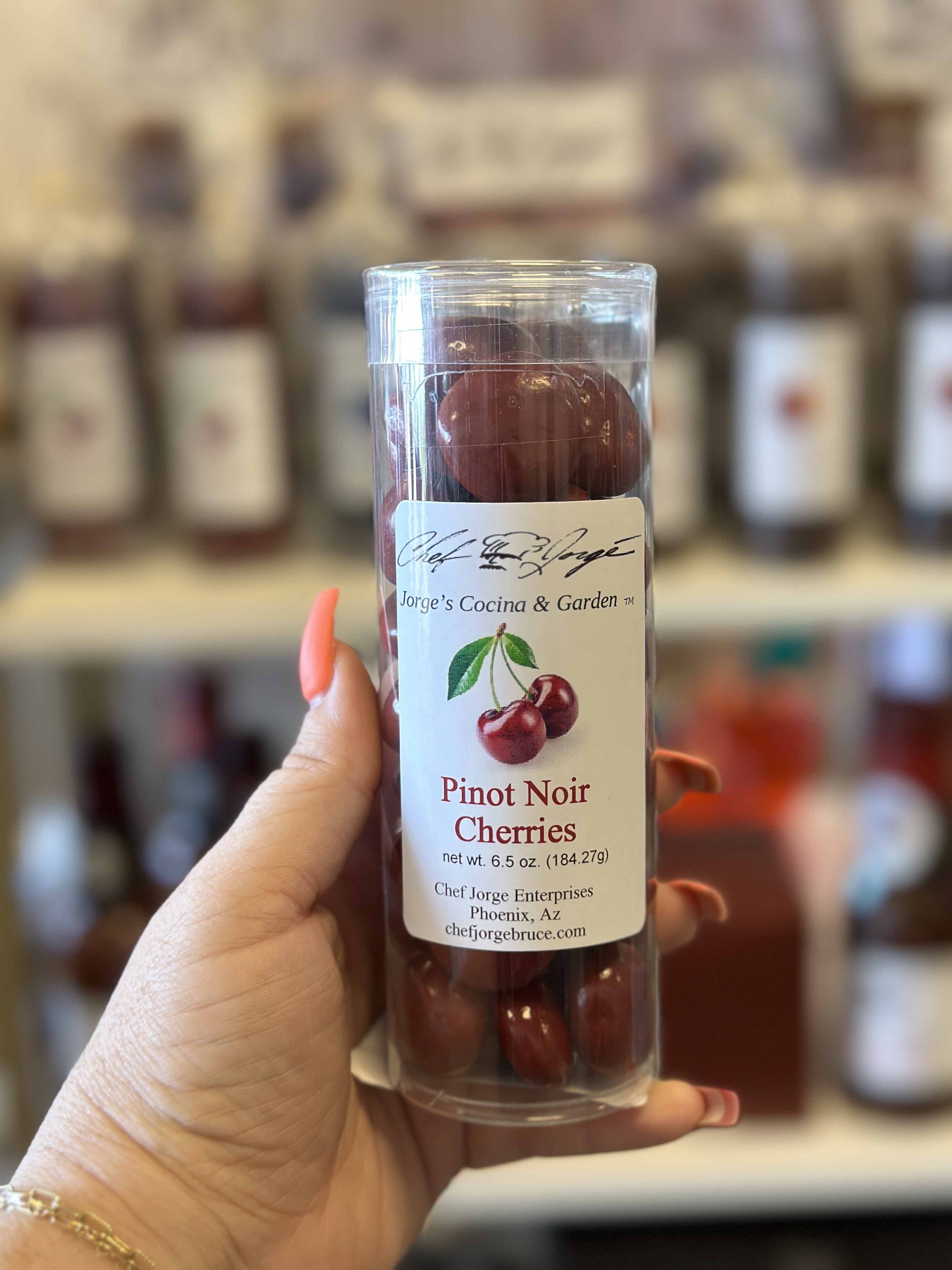 Woman holding a container of candied cherries