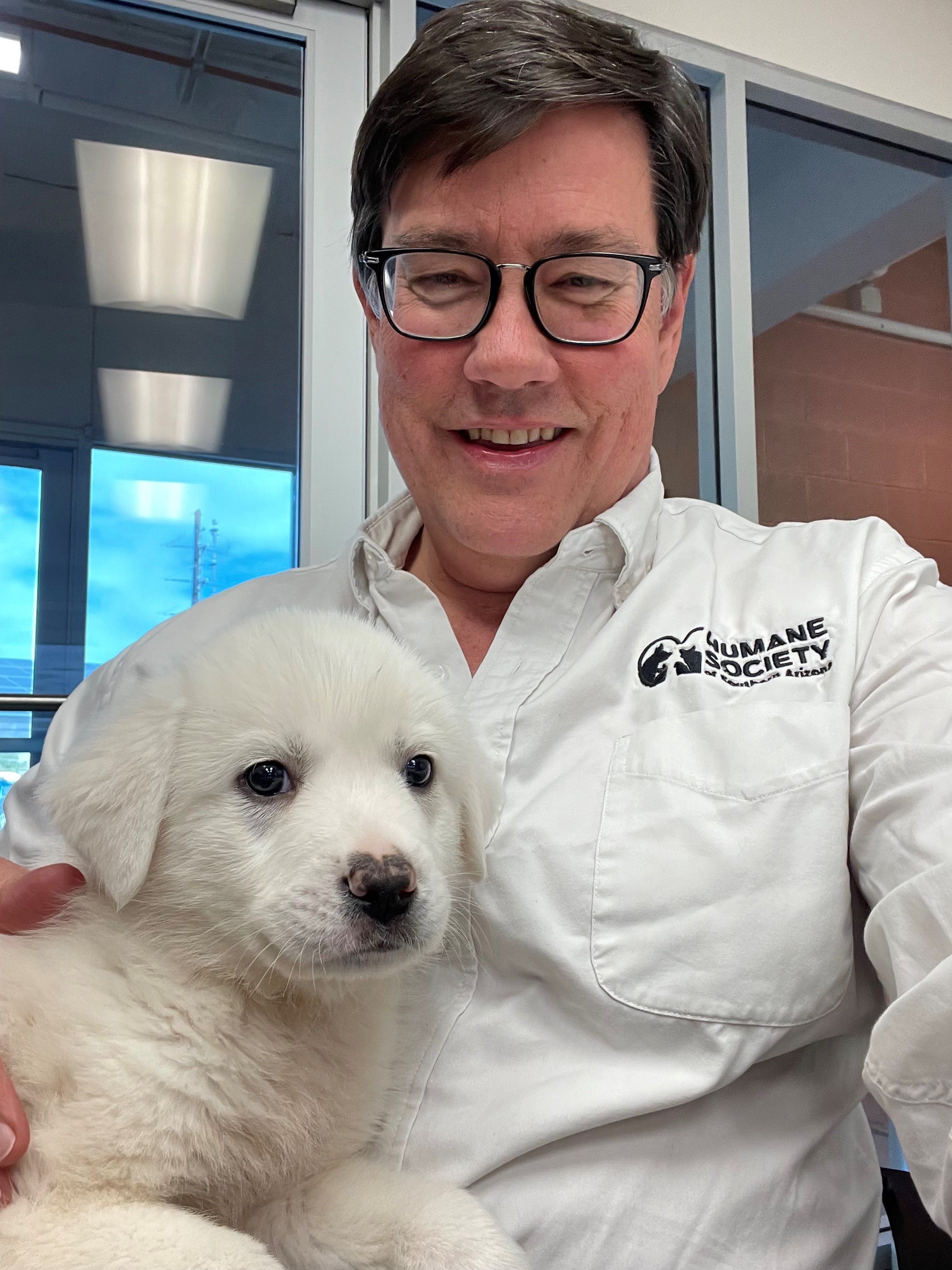 A man holding a puppy