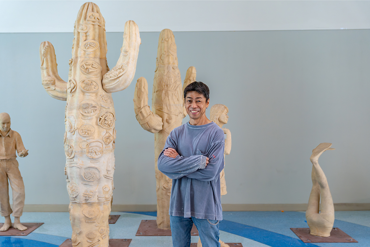 Man standing in front of an art exhibit