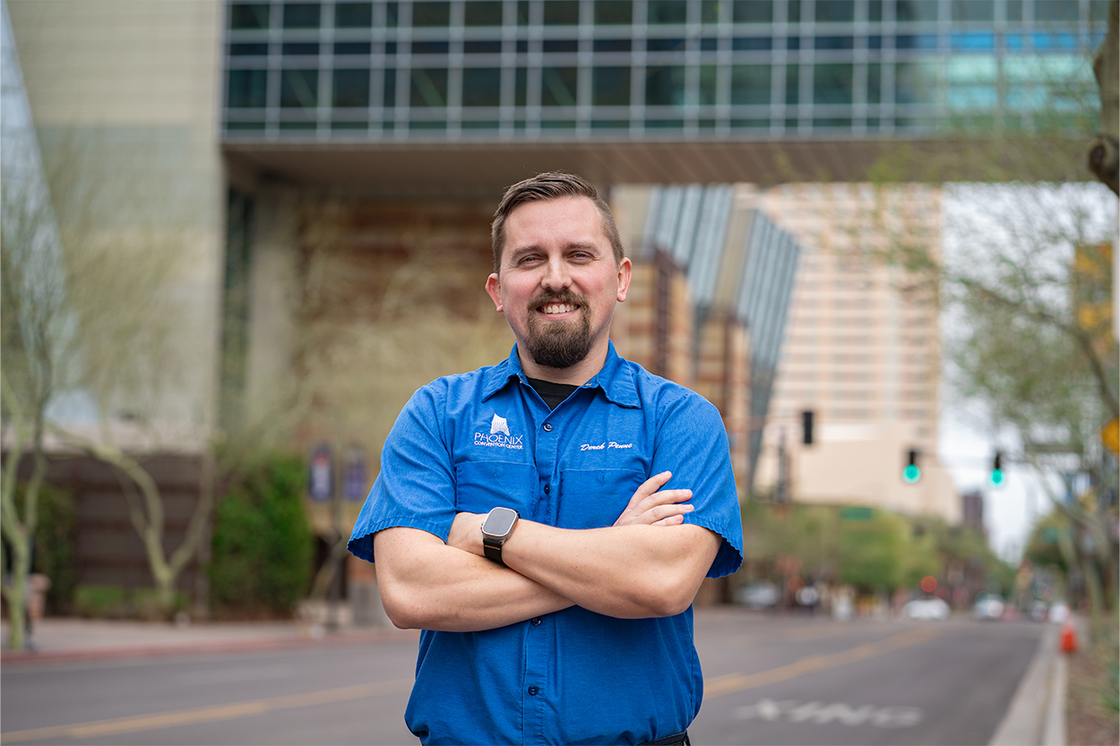 Man poses for a photo outside