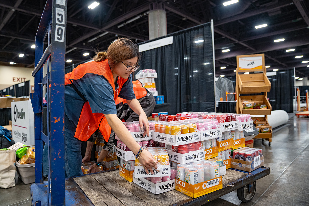 Person places food donations on a palette to be taken by nonprofit organizations.