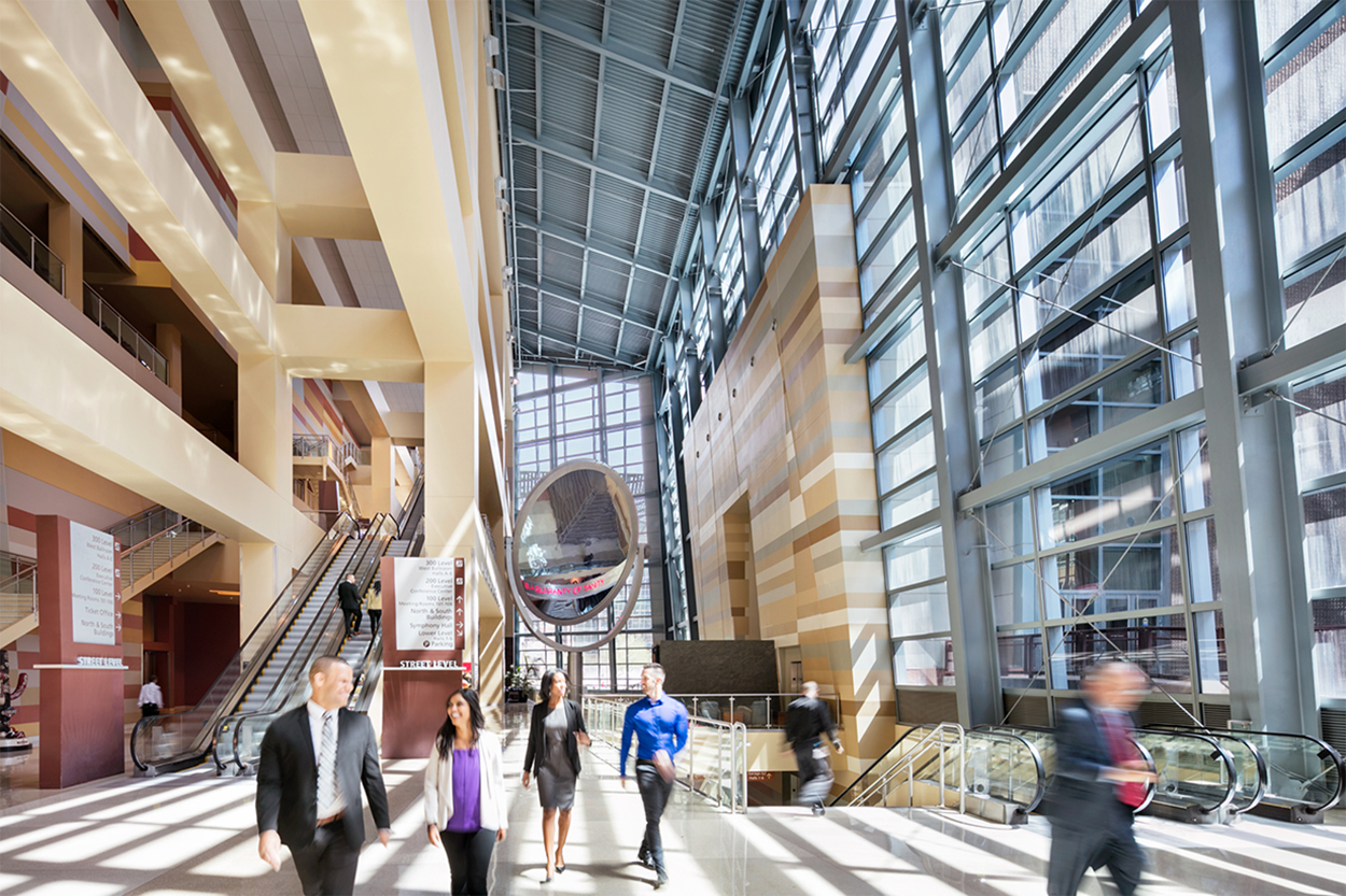 People walking through the West Building atrium.